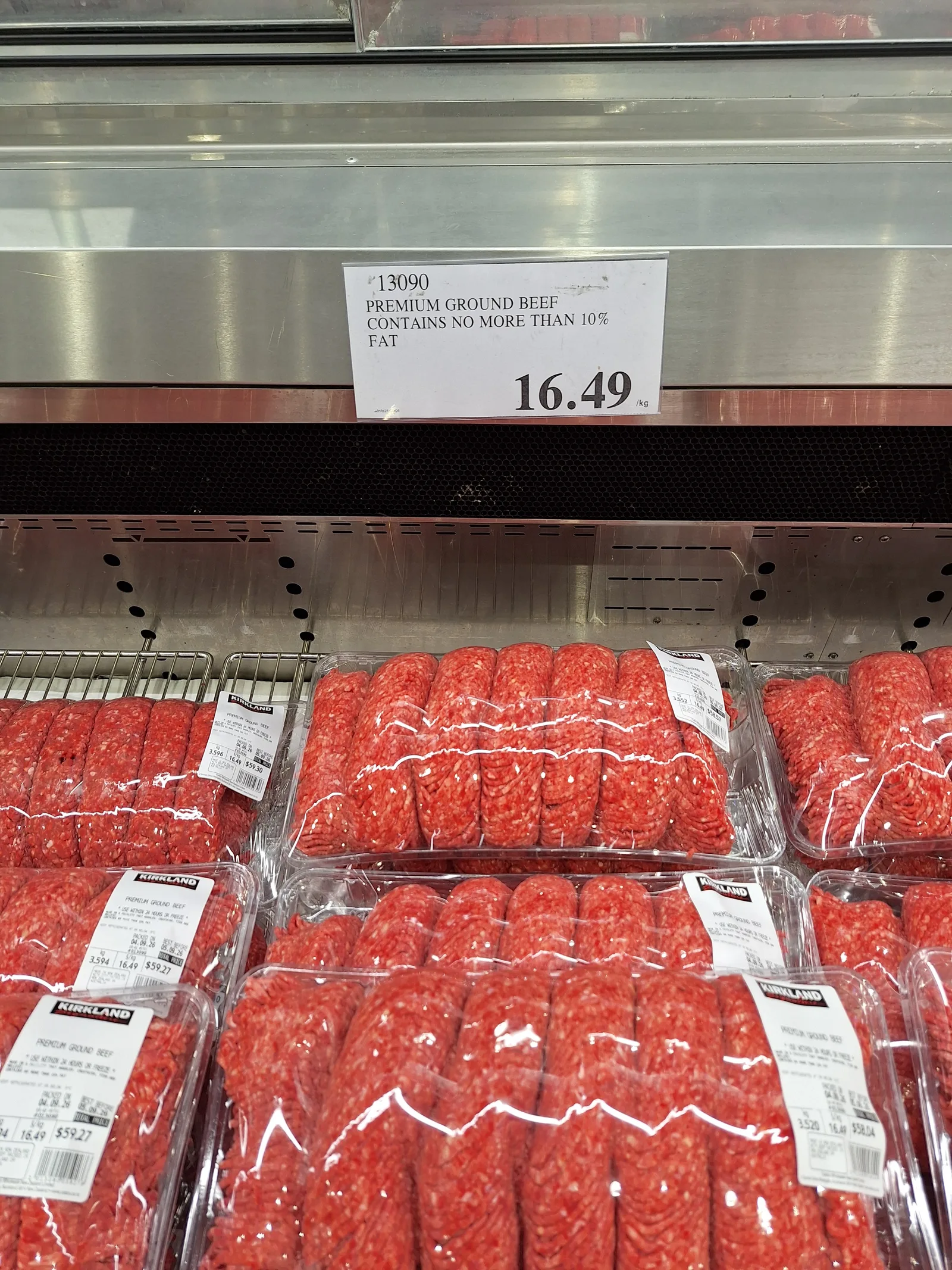Costco Westgate premium ground beef shelf display with a price sign showing 16.49 dollars per kilogram